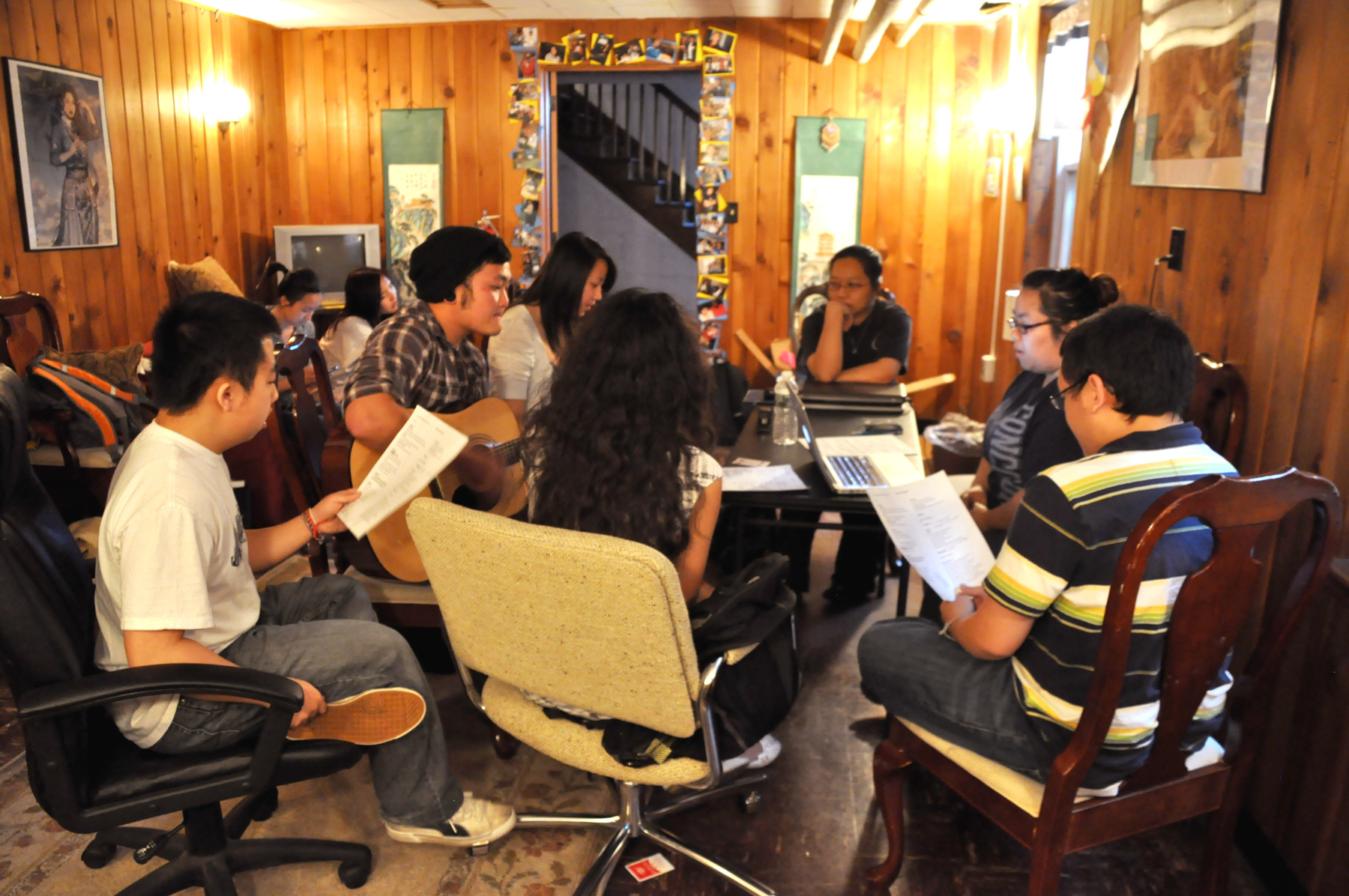 Students sitting in a circle playing music in the Hmong Center
