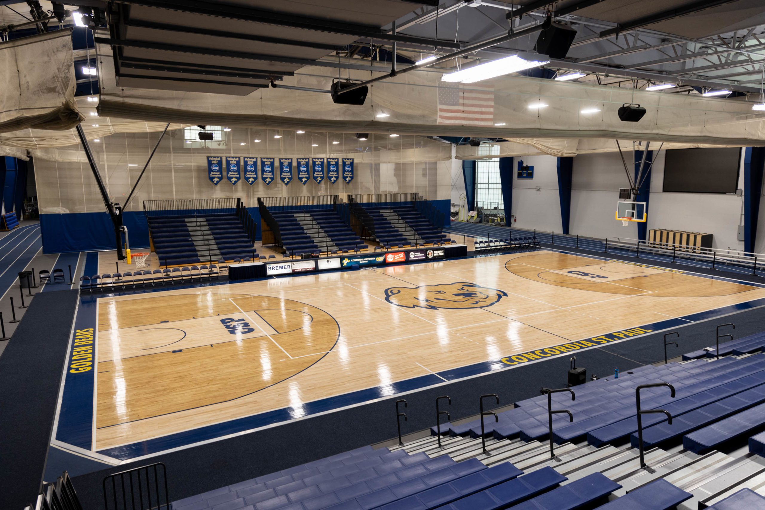 Basketball court with blue and silver bleachers next to it