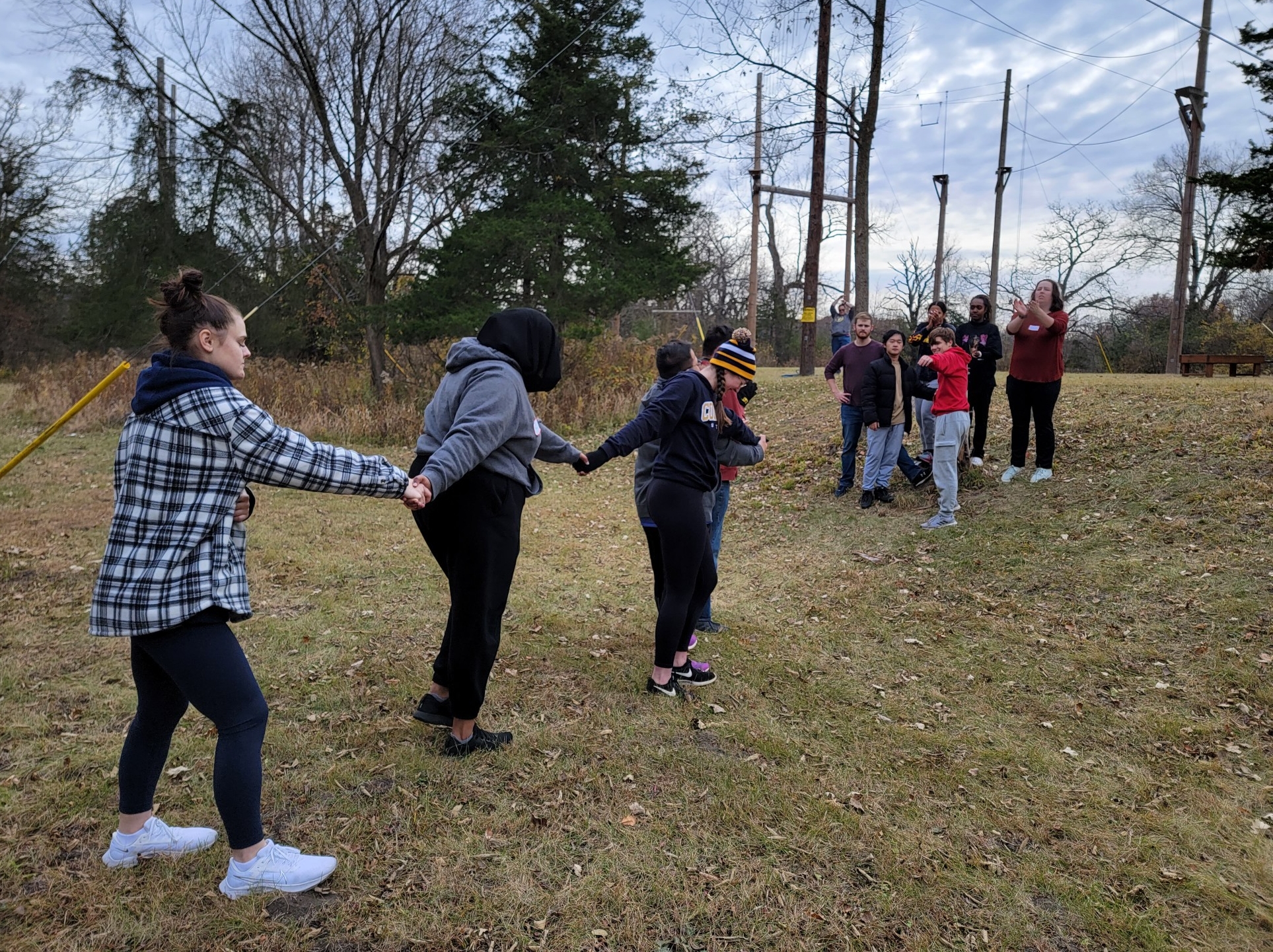 students participating in a team building exercise outside